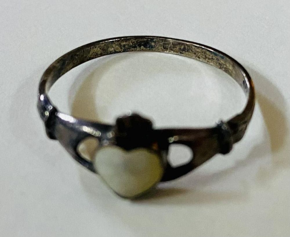 Lot 195: Mother of pearl Claddaugh heart ring