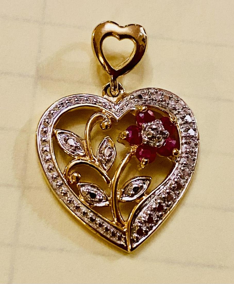Lot 245: Ruby heart pendant floral