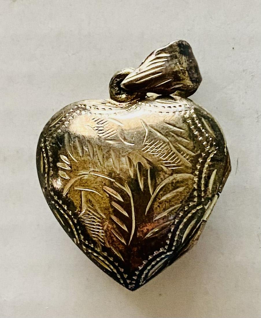 Lot 257: Sterling engraved heart locket