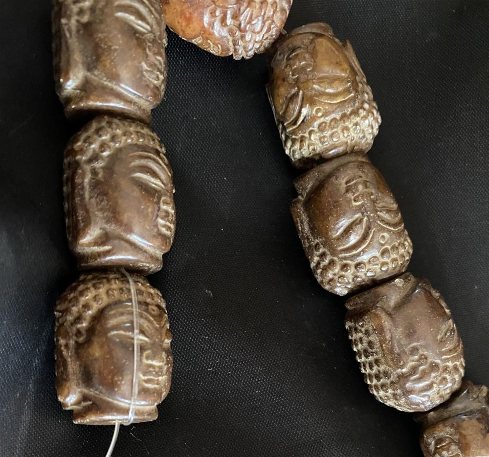 Lot 262: Buddha chocolate jade beads carved and drilled