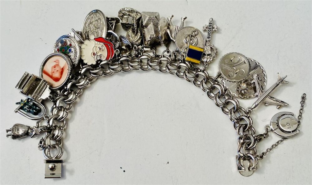 Lot 312: Vintage sterling charm bracelet loaded