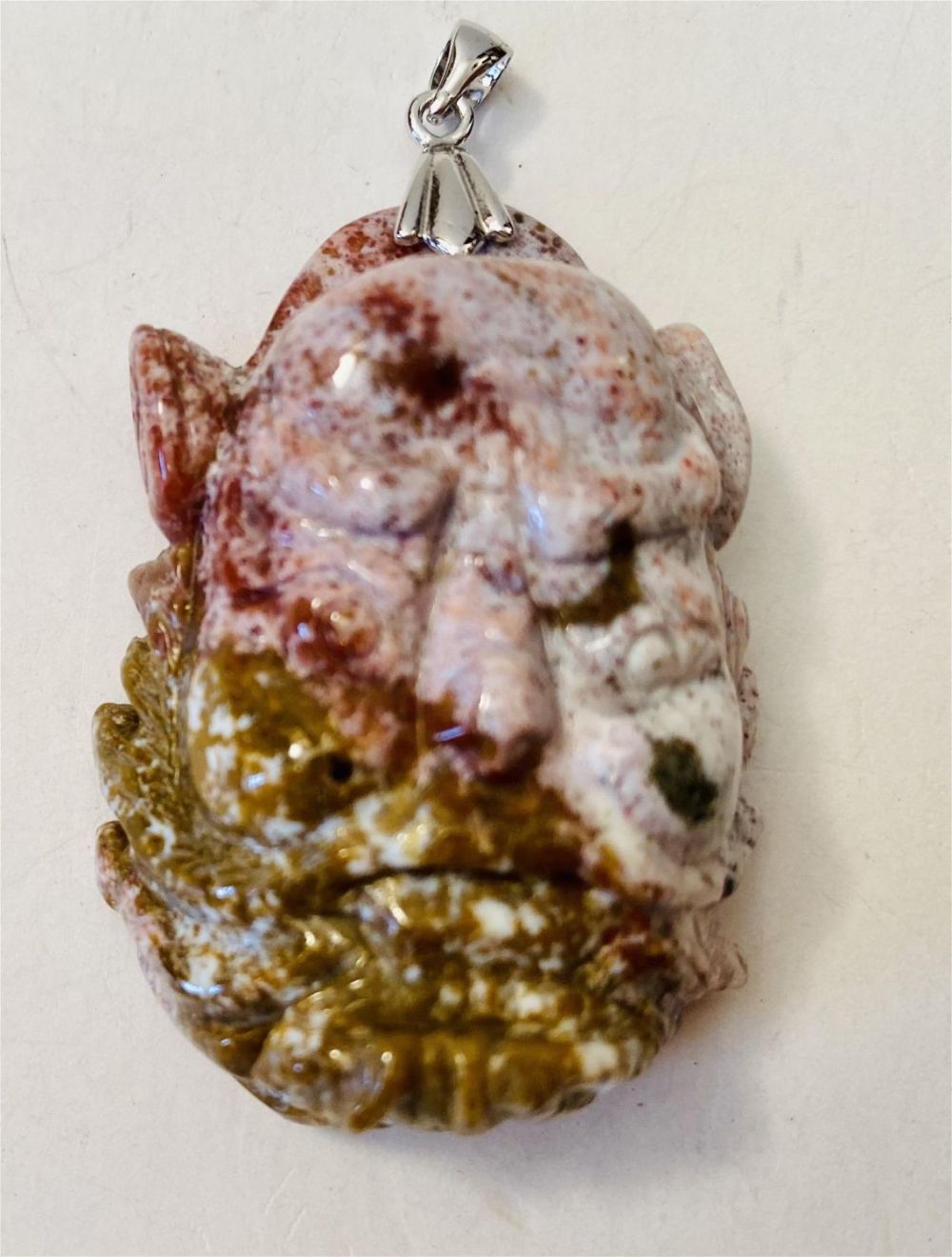 Lot 370: Carved jasper demon pendant