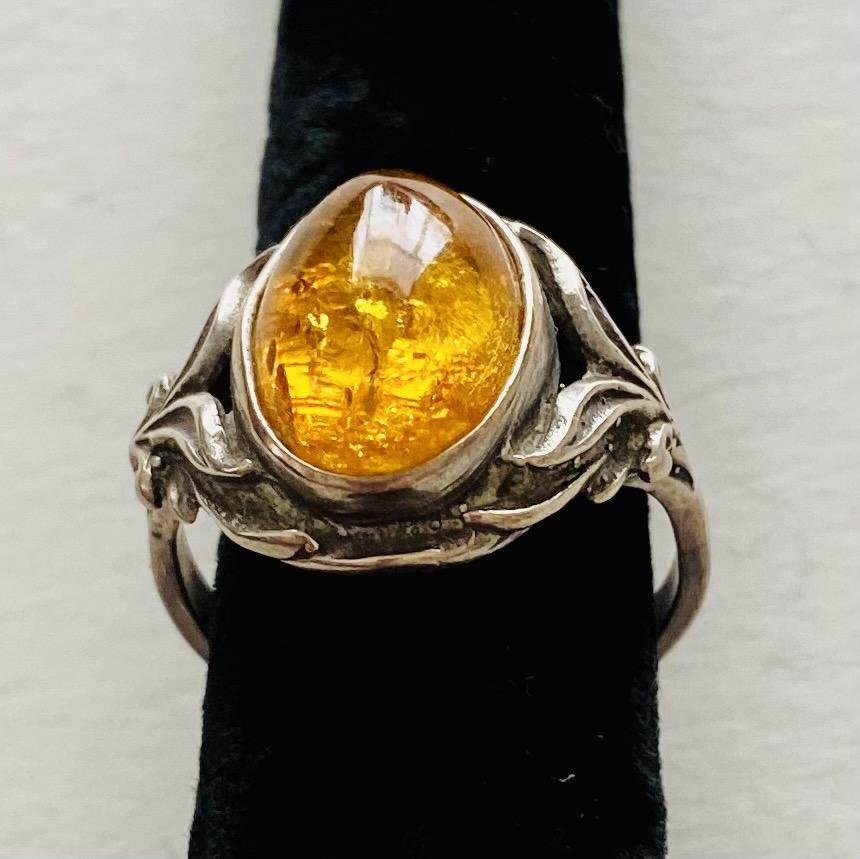 Lot 187: Amber cabochon ring fancy setting sterling