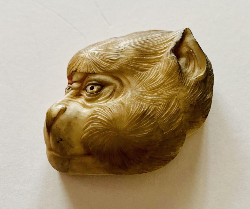 Lot 188: Monkey face carved bone head