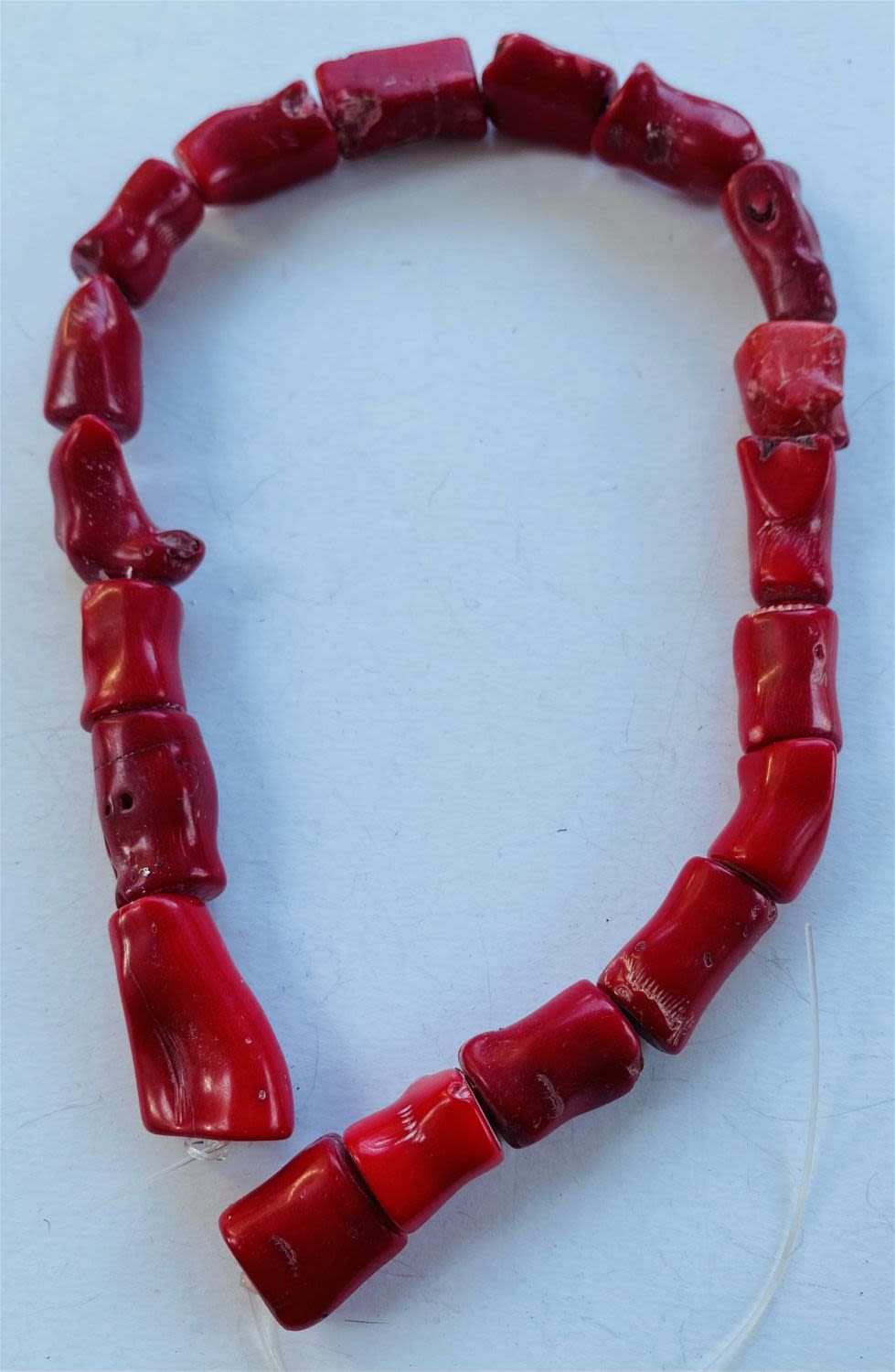 Lot 253: Red coral beads drilled strand
