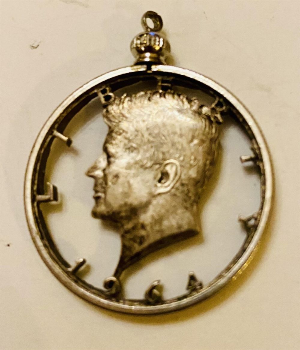 Lot 374: Kennedy half dollar cut out pendant