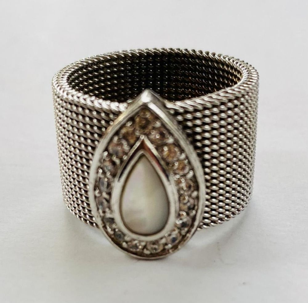 Lot 390: Mother of pearl ring-clear stones around