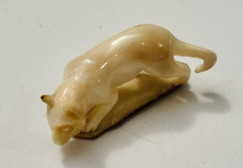 Lot 398: Carved bone bobcat /cat fossilized material