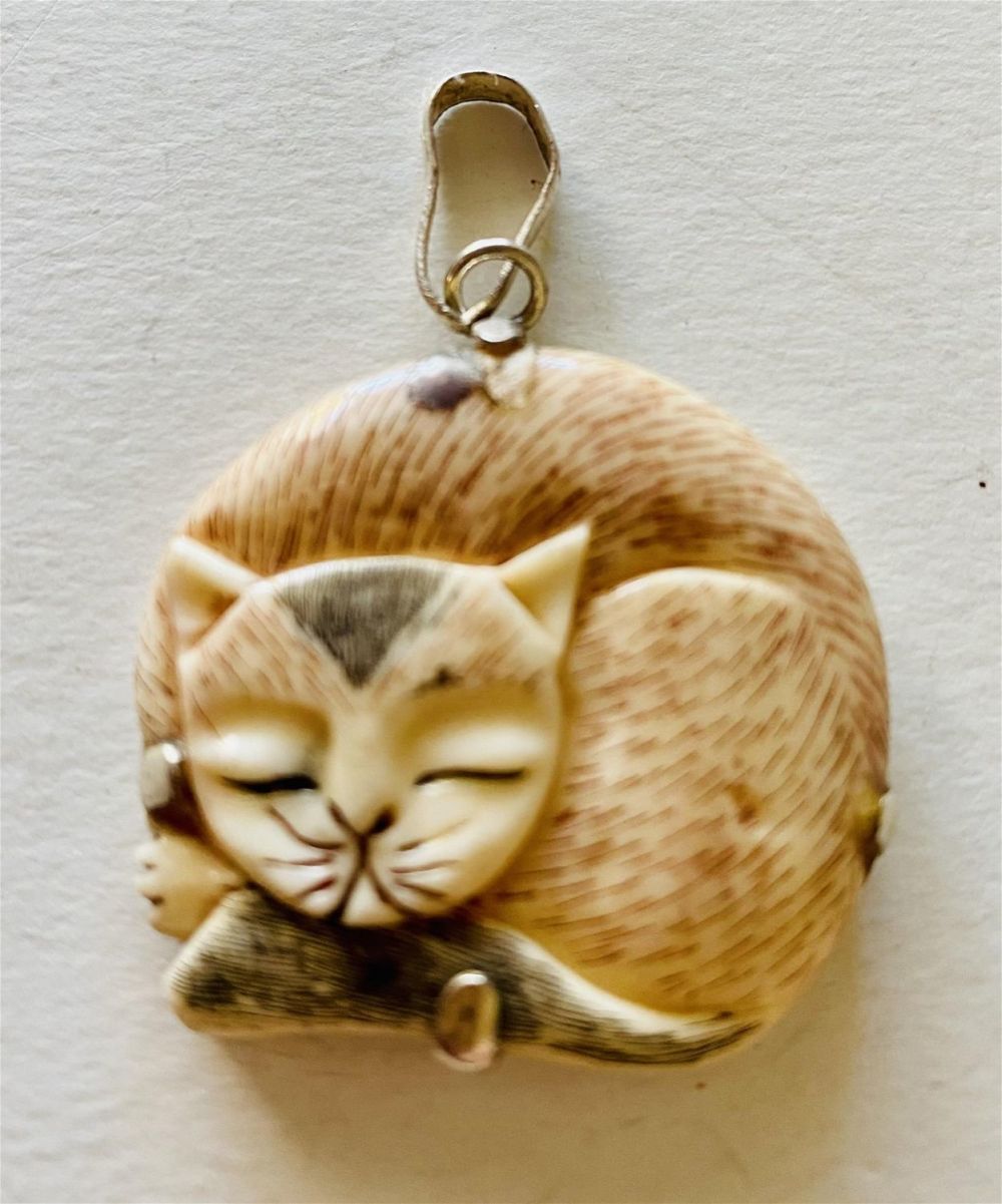 Lot 455: Cat pendant bone polychromed