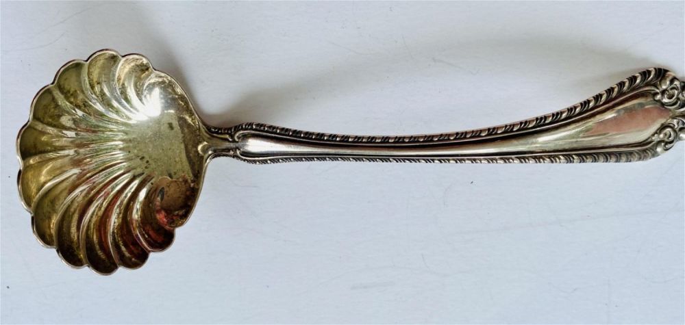 Lot 226: Sterling scalloped ladle marked