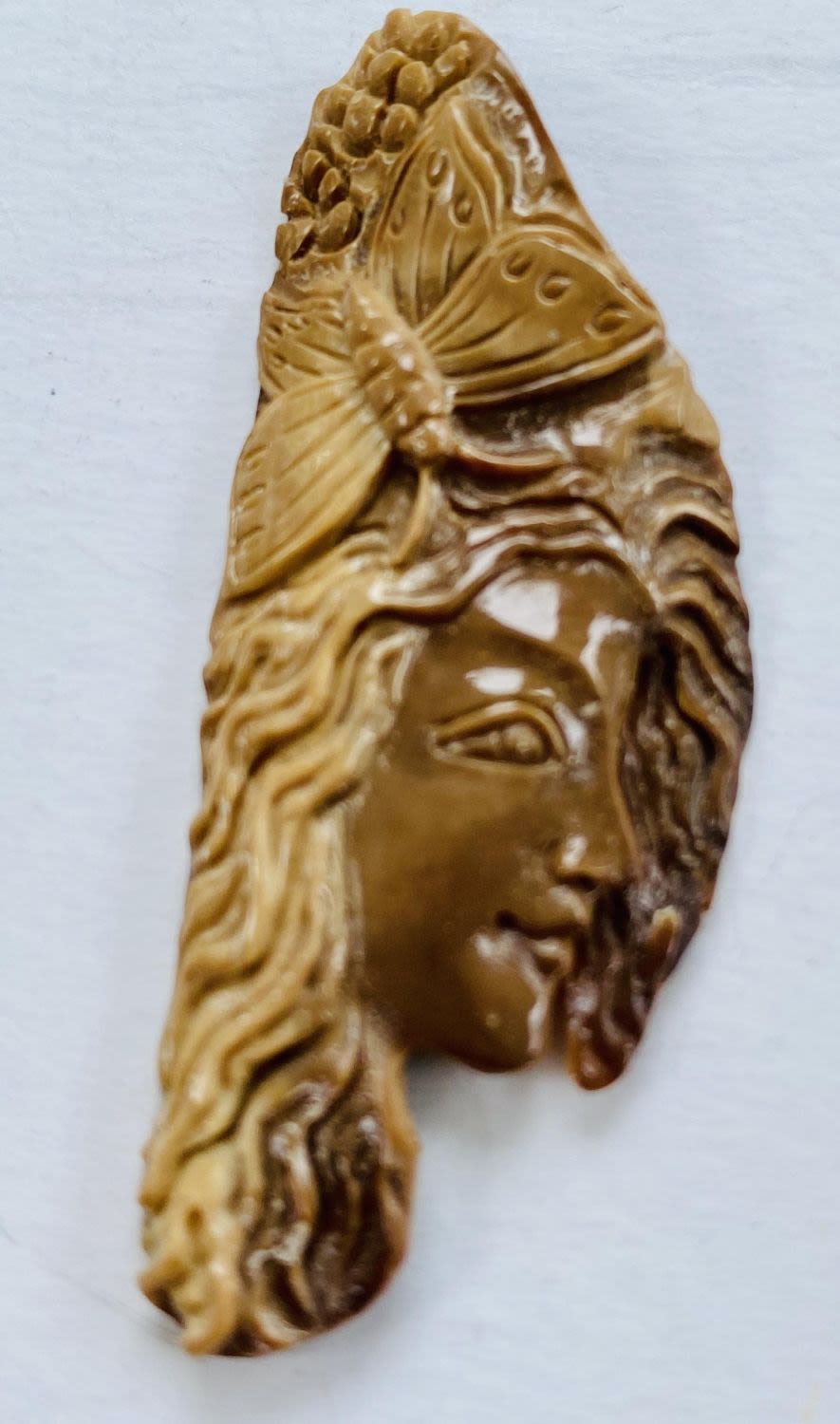 Lot 266: Carved fossilized bone lady/butterfly