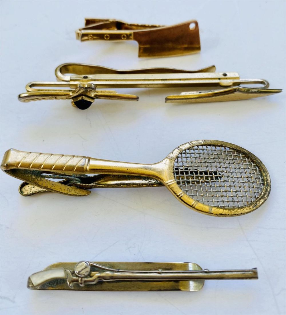 Lot 297: 4 tie bars vintage -tennis racket, chopper knife plus