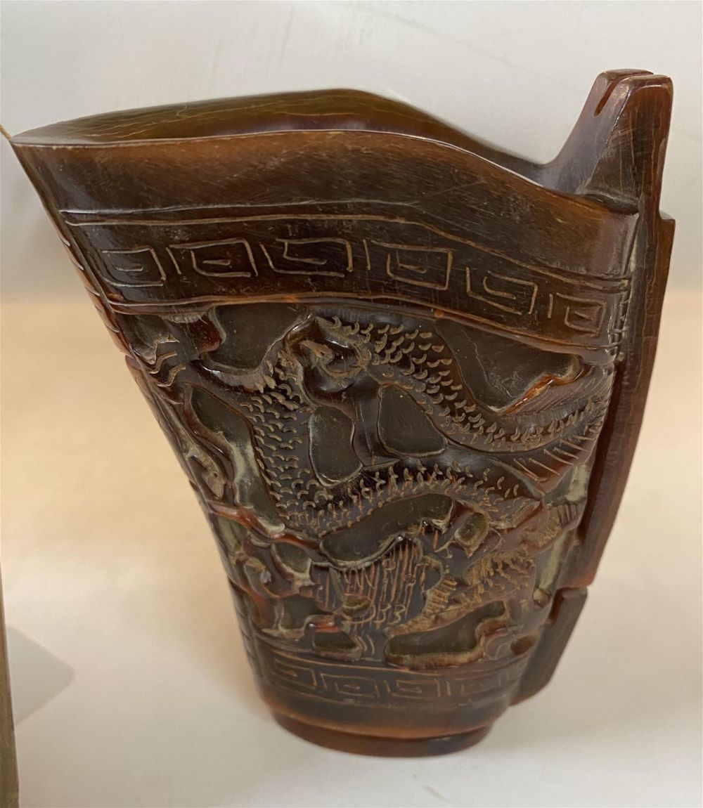 Lot 321: Libation horn cup carved