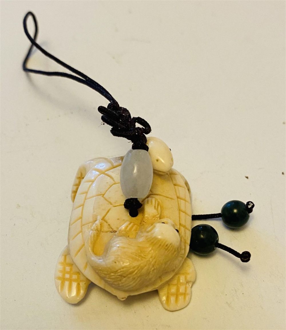 Lot 364: Bone carved turtle with monkey pendant