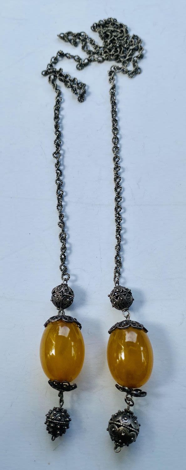 Lot 405: Silver tone chain with large amber beads