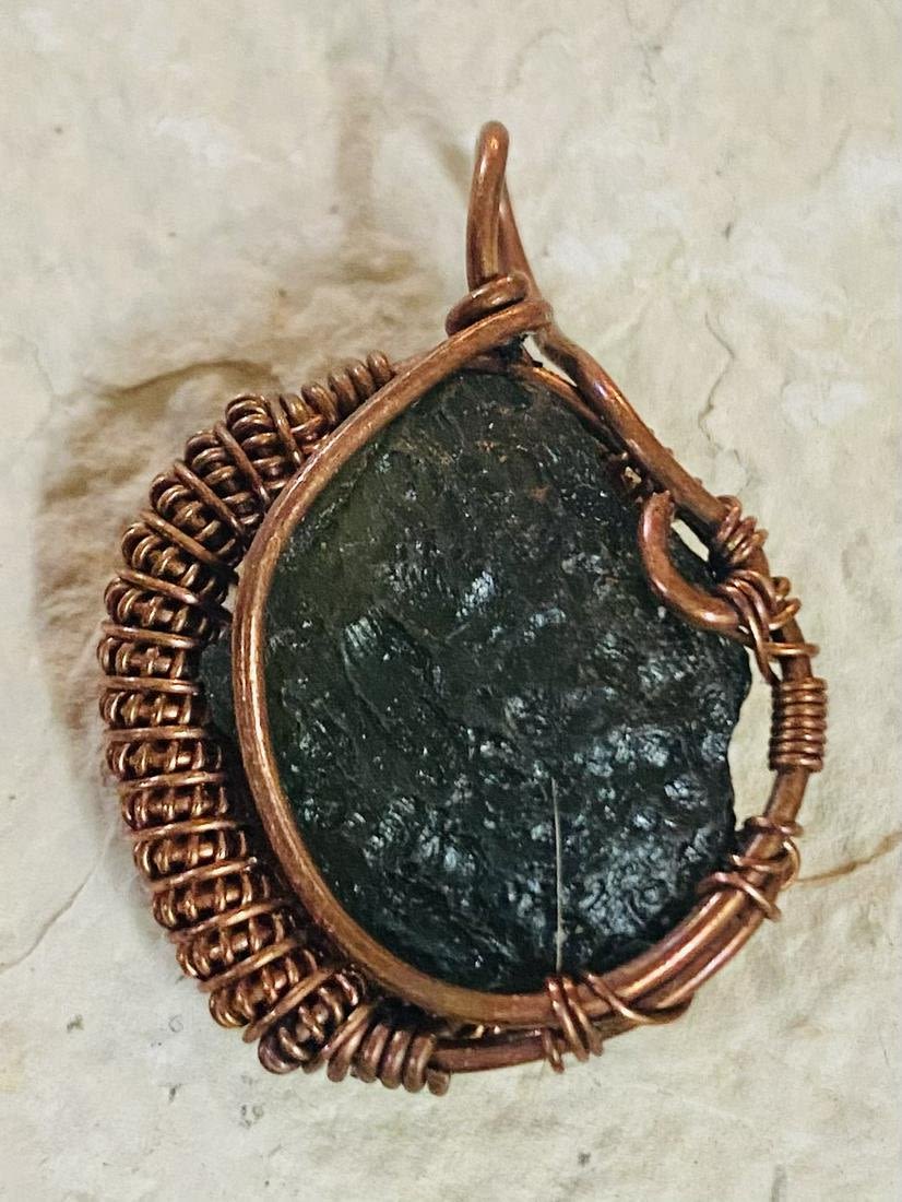 Lot 495: Moldavite specimen pendant- wire wrapped in copper