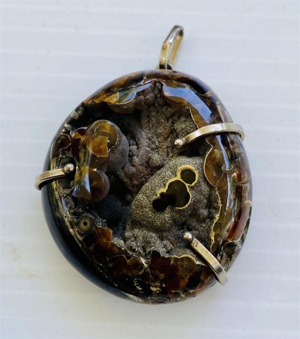 Lot 270: Pyritized ammonite sterling pendant