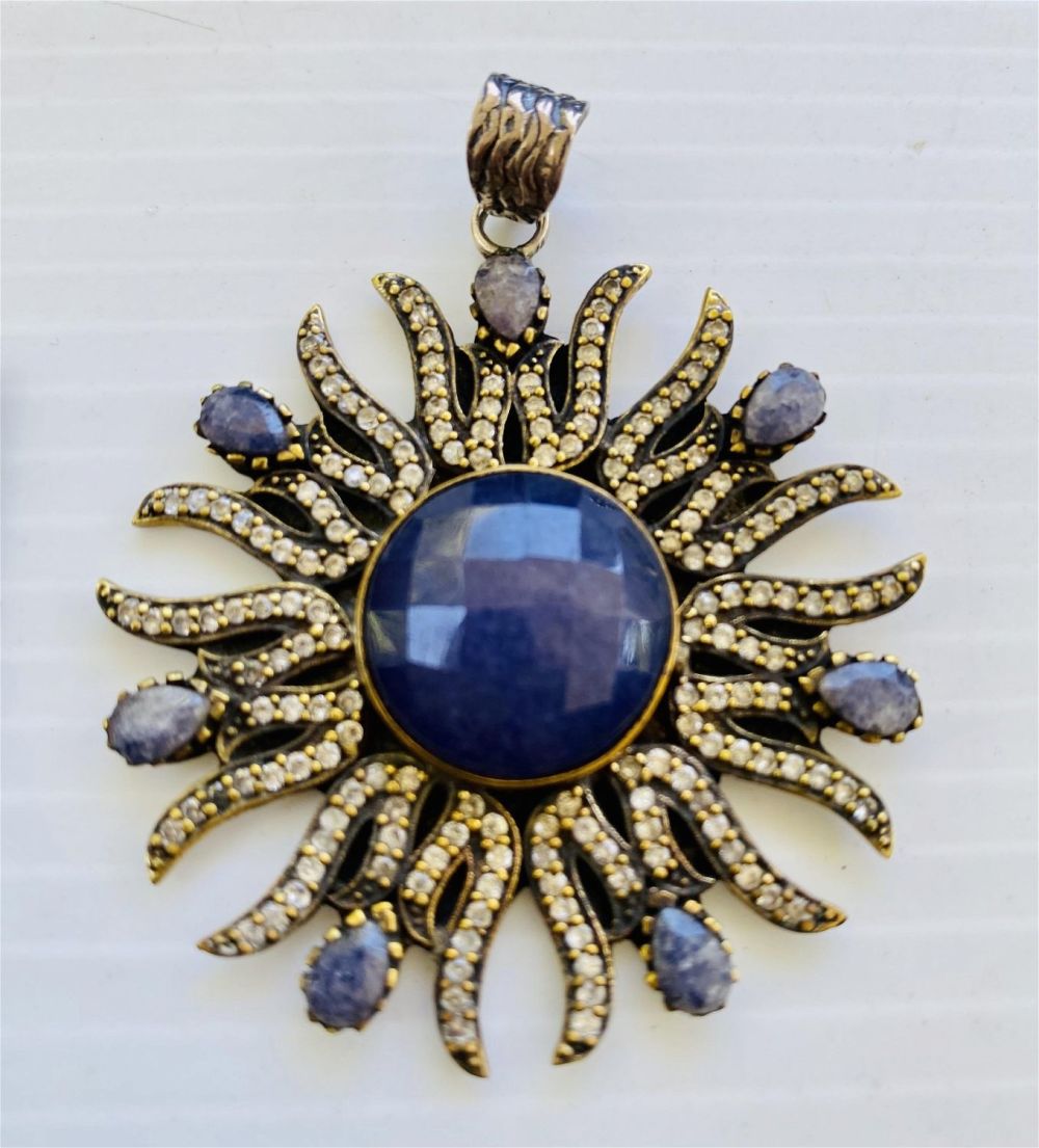 Lot 318: Large sapphire starburst sterling pendant