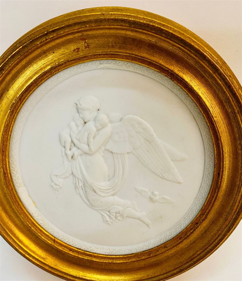 Lot 382: Round Victorian bisque plaque framed angel/babies
