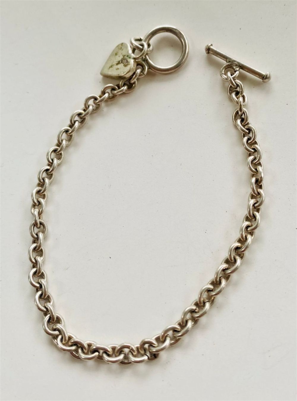Lot 407: Link sterling bracelet -heart charm