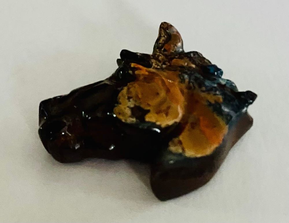 Lot 478: Natural boulder opal carved horse head
