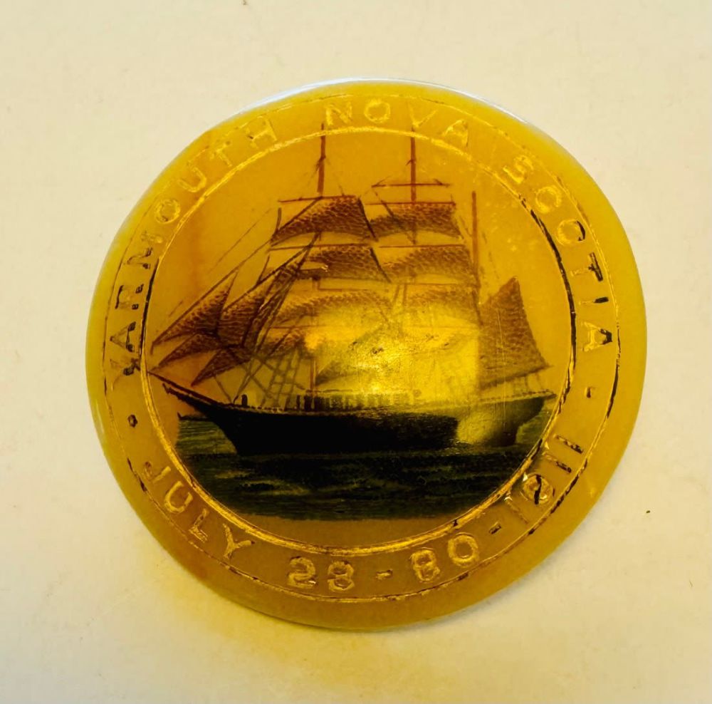 Lot 314: Yarmouth Nova Scotia pin - bakelite? with ship