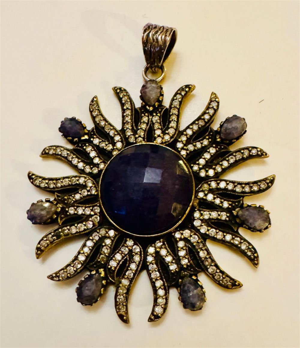 Lot 118: Sapphire sunburst sterling pendant