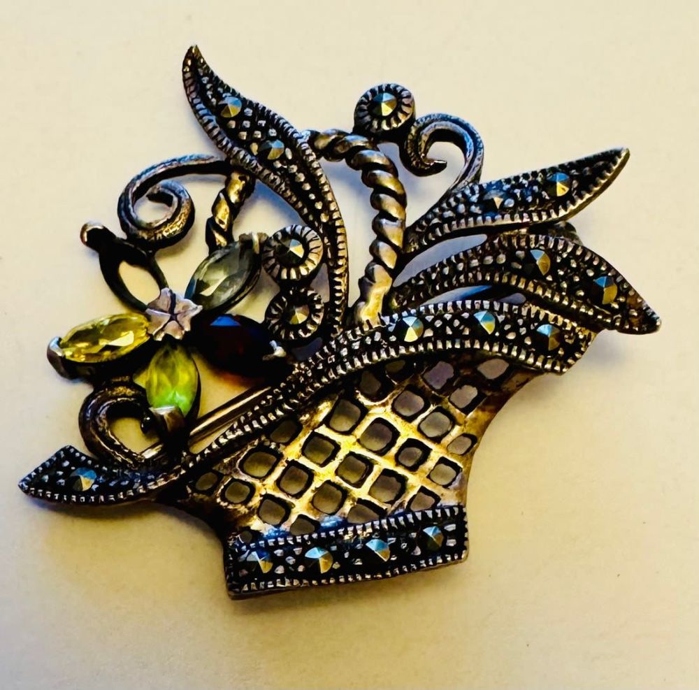 Lot 221: Sterling marcasite flower basket pin.