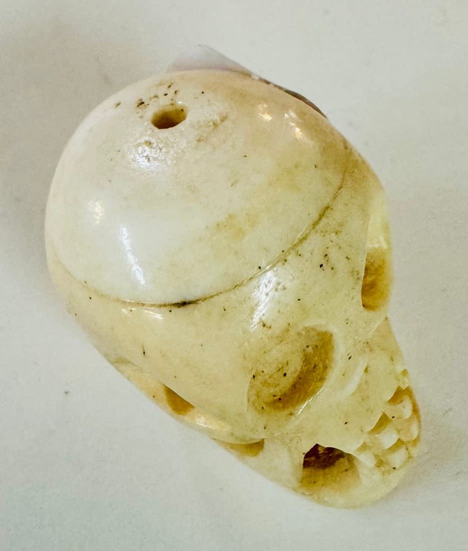 Lot 252: Bone carved skull drilled