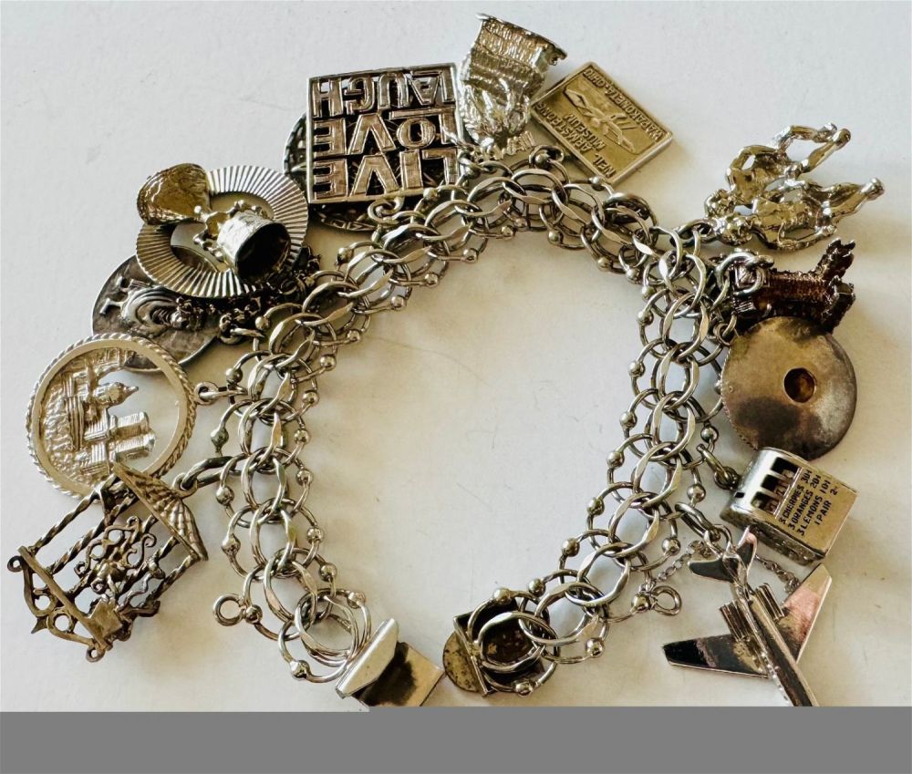 Lot 300: Sterling charm bracelet vintage /many charms