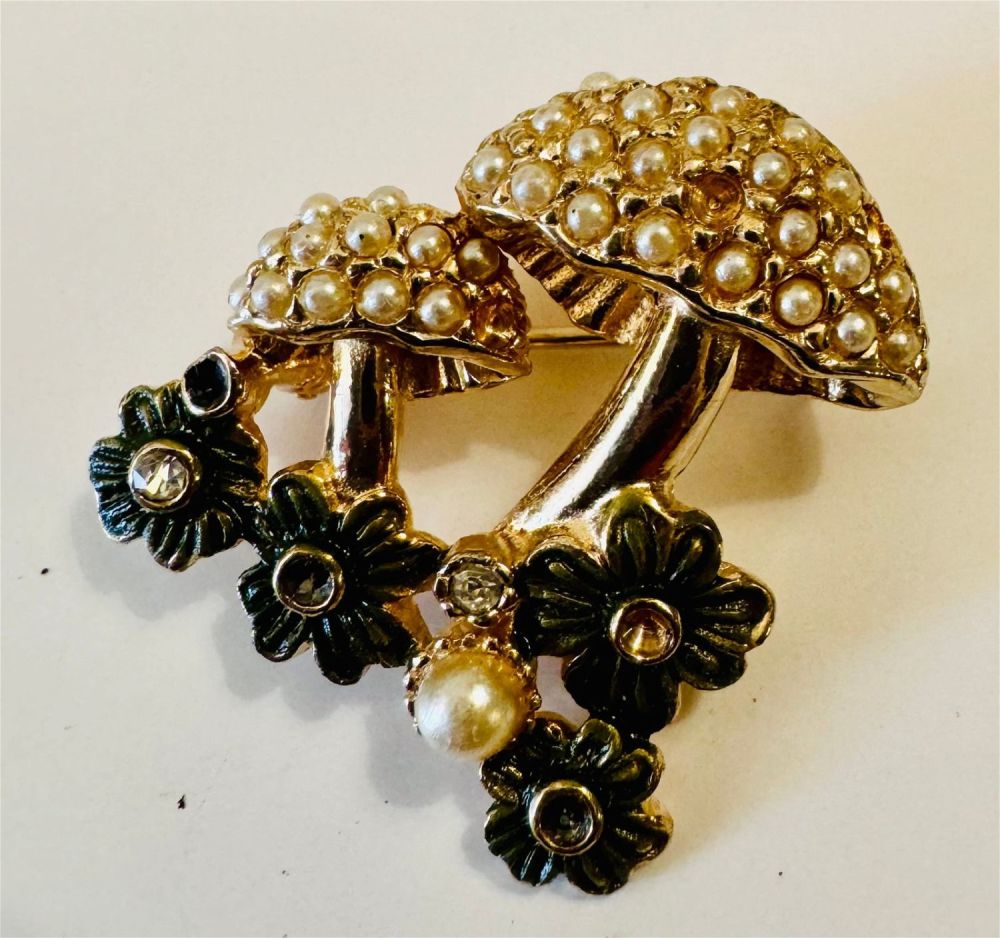 Lot 304: Ciner signed flower pin with mushroom like flowers encrusted with seed pearls. About 1 inch across.
