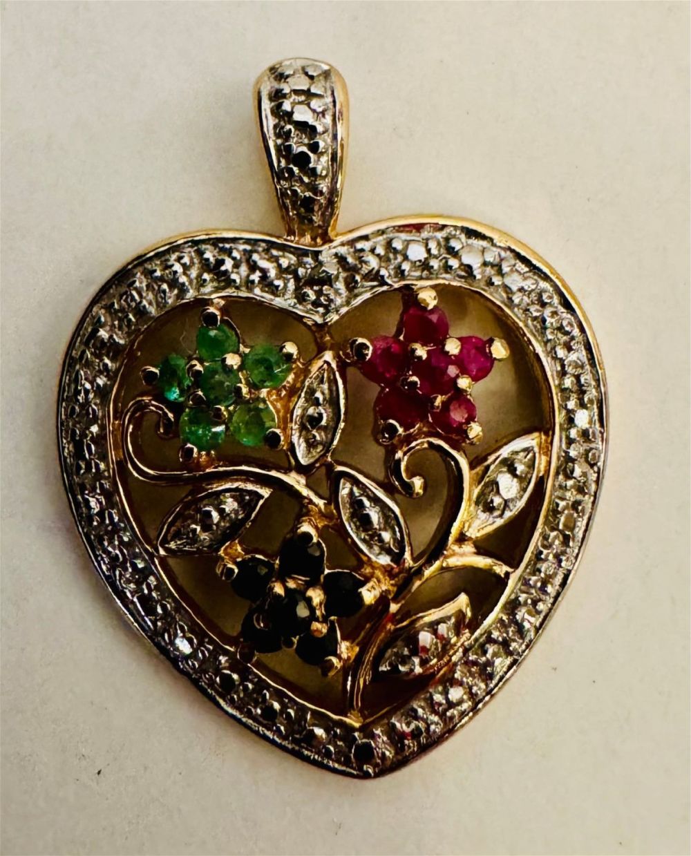 Lot 318: Vermeil emerald, sapphire and ruby heart pendant