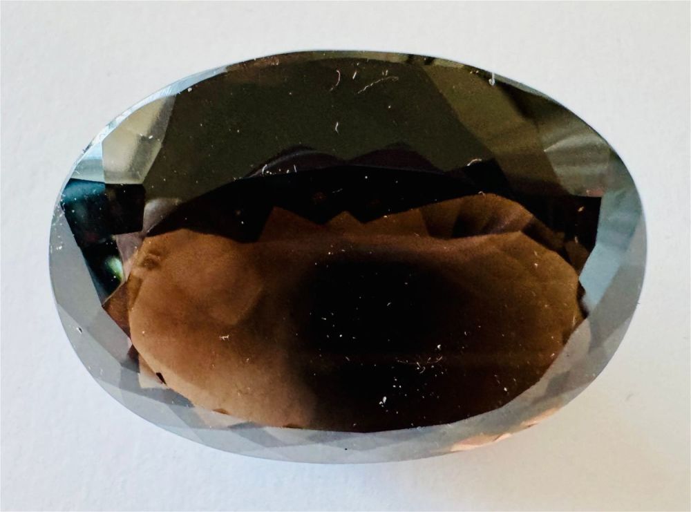 Lot 319: Smoky quartz faceted oval gemstone -massive