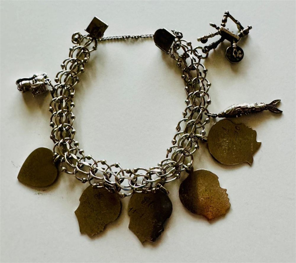 Lot 387: Sterling charm bracelet/7 charms antique