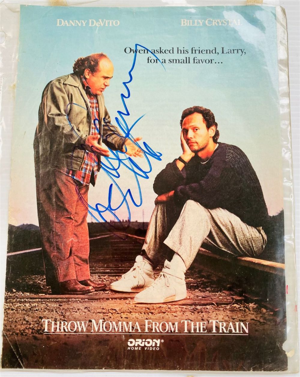 Lot 412: Danny Devito signature on advertisment of movie page