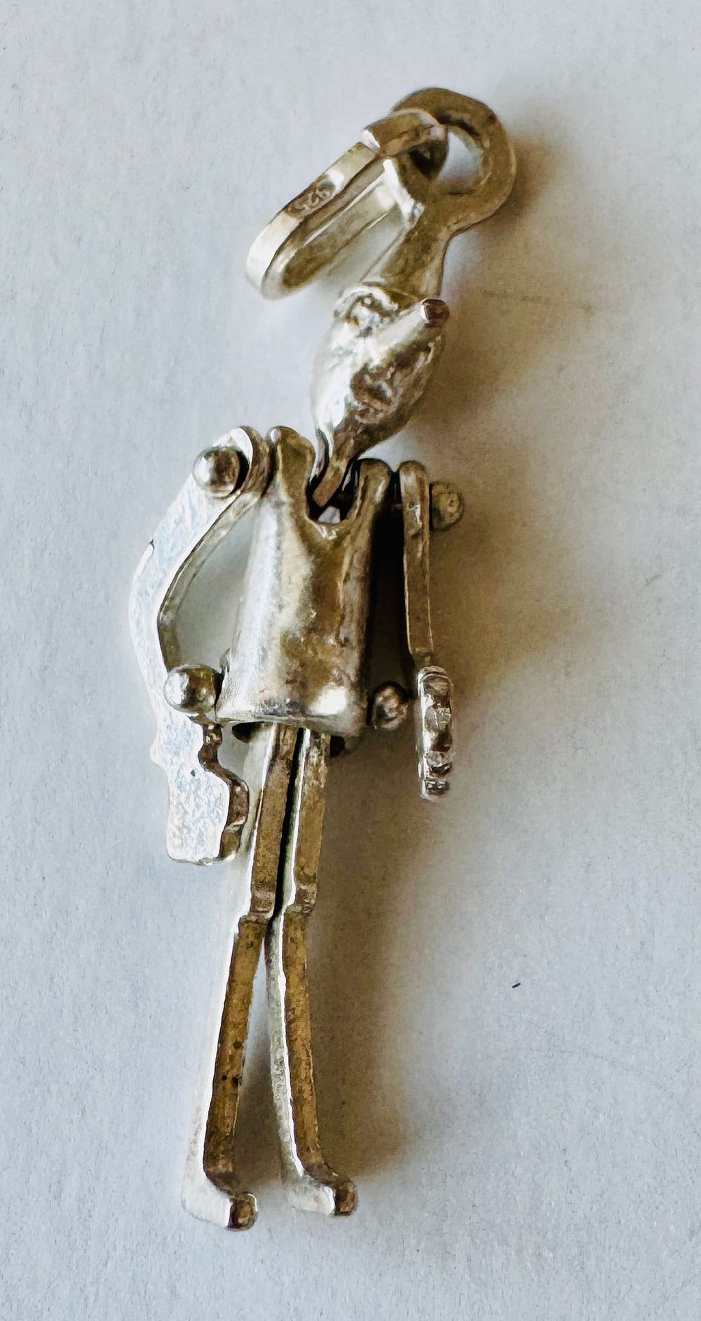 Lot 195: Sterling tin man reticulated vintage pendant/charm