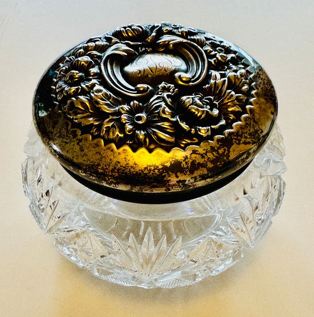 Lot 251: Antique crystal vanity jar/sterling repousse lid