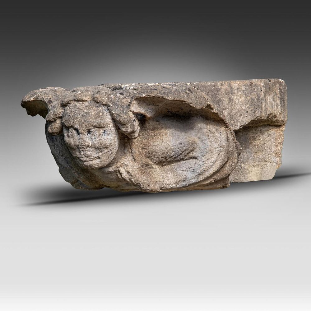 A 15thC gargoyle shaped as an angel bearing a banderole 37 x 108 x 64 cm. (14.5 x 42.5 x 25.2 in.). 