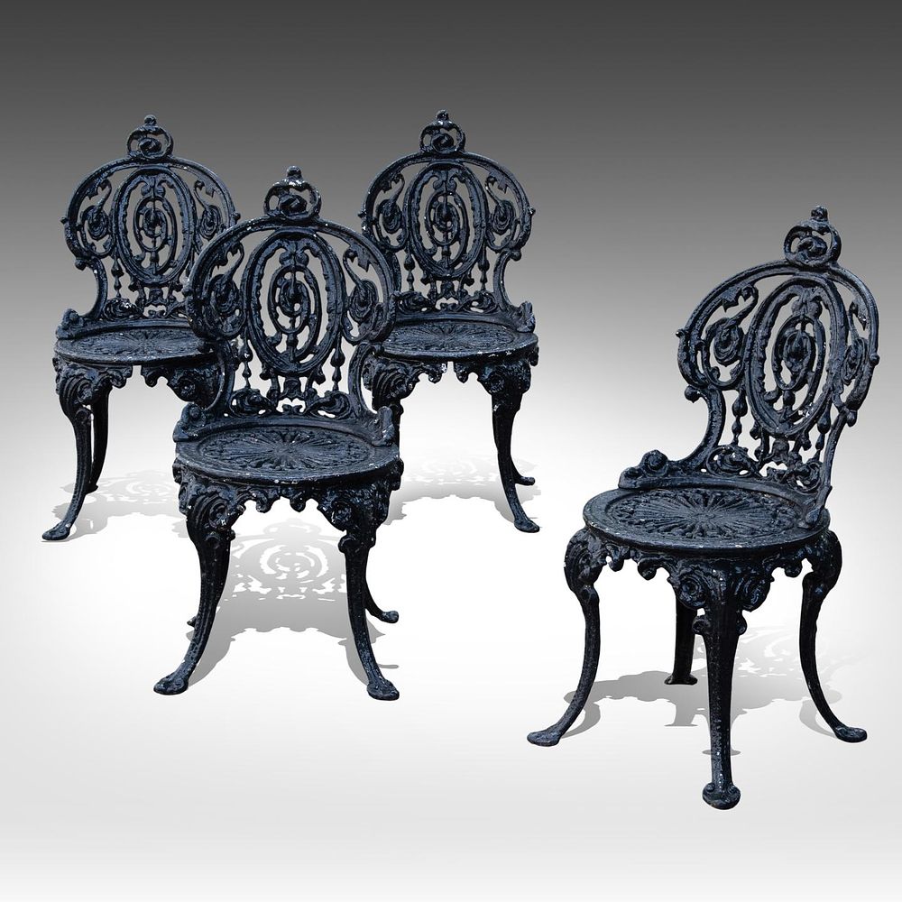 A set of four French black painted cast iron garden chairs with pierced backs and seats 83 x 40 