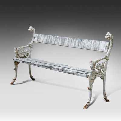 A garden bench with cast iron legs and a wooden slatted seat and back 96 x 175 x 56 cm. (37.8 x 