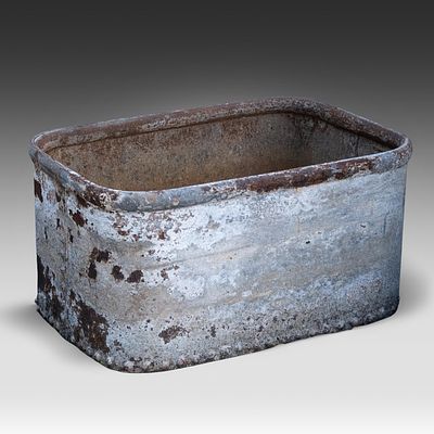 A rectangular iron cistern with riveted bottom edge 34 x 67 x 47 cm. (13.3 x 26.3 x 18 1/2 in.). 