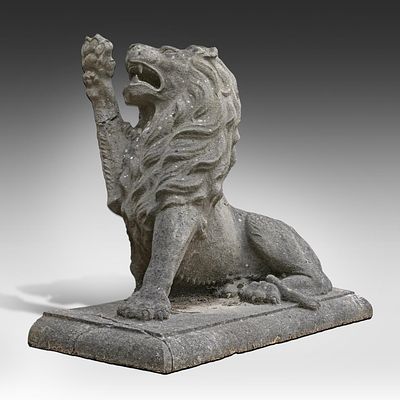 A blue stone garden sculpture of a lion 80 x 110 x 47 cm. (31 1/2 x 43.3 x 18 1/2 in.). A blue 