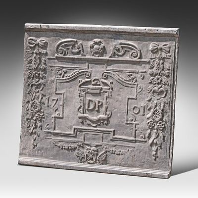 A cast iron fireback, dated 1701 and monogrammed DP 77 x 88 cm. (30.3 x 34.6 in.). A cast iron 