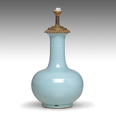 A Chinese celadon-glazed bottle vase, marked Yongzheng, fixed with a lamp mount at the top 