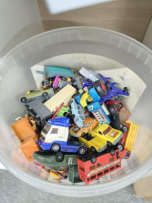 plastic tub of assorted vehicles