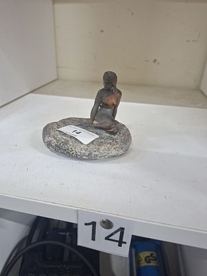 female figure on pebble