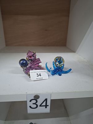 baby dragon holding crystal ball and glass octopus - as seen