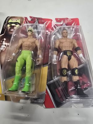 A Pair of Mattel WWE Basic Series Action Figures featuring Triple H and Brutus The Barber Beefcake