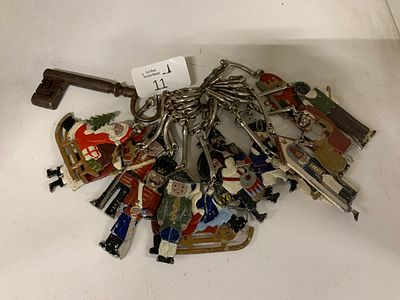 A Collection of Hand-Painted White Metal Christmas and Military Themed Charms on an 