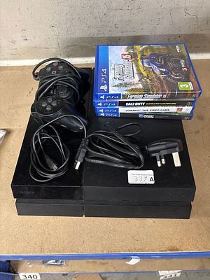 A Sony PlayStation 4 Console untested with DualShock 3 Controller and Games